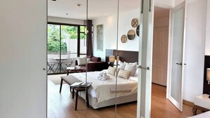 A modern bedroom with a bed, bedside tables, a nightstand, a window, and a balcony. - Quiet-NearTerminal21 Malls/BTSNana/SkylineView/Gym (Khlong Toei)