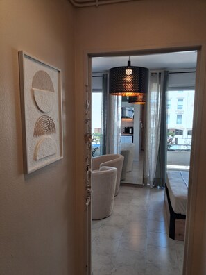 A hotel room with a dining area, a modern pendant light, and a framed artwork on the wall. - Studio with terrace (Avignon)