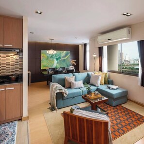 A modern living room with a sofa, coffee table, and a city view. - KingBed|BTS&Park»5min|ParkView|Gym|Washer|FastWiFi - Apartment (Khlong Toei)