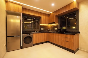 A modern kitchen with wooden cabinets, stainless steel appliances, and a large window. - Charming, family-friendly 2-bedroom apartment with AC in Marrakesh Targa (Marrakesh)