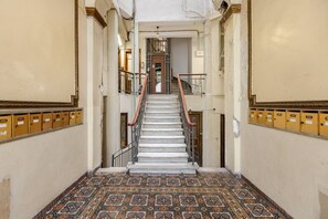 A staircase with patterned flooring leading to a door at the top. - #ALS_ON AIR LUXURY ROOFTOP (Thessaloniki)