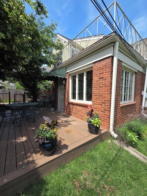 A brick house with a covered patio, a window, and a door. - Welcome to Brookside Mod Cottage: Spacious and group friendly! (Kansas City)