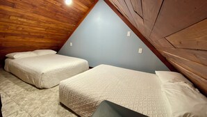 A room with two beds, wooden ceiling, and light blue walls. - Gregory's Lodging and General Store (Shelbyville)