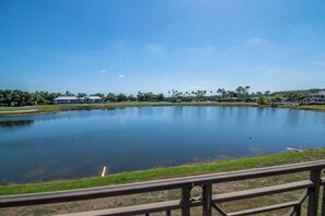A tranquil lake with a clear sky, surrounded by greenery and buildings. - Expanded Saddlebrook 2bed/2bath Condo. Sleeps 8 (Zephyrhills)