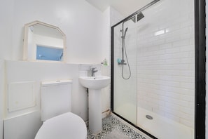 Separate bathtub and shower, deep-soaking bathtub, hair dryer, towels