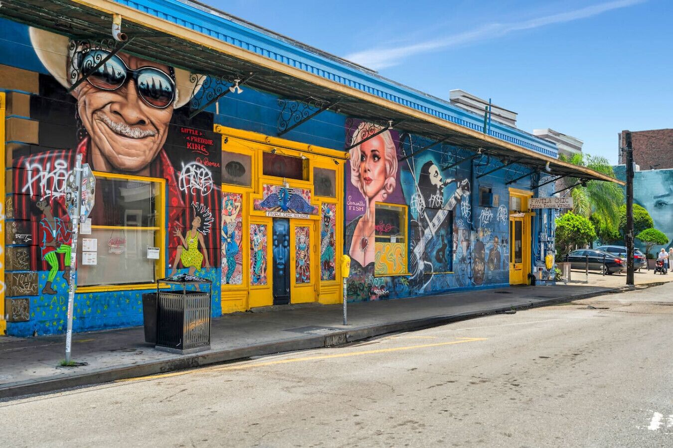 A colorful building with murals and a yellow awning.