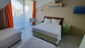 A hotel room with a bed, a bedside table, a TV, and a window with curtains. - TANGO PANSIYON (Koycegiz)