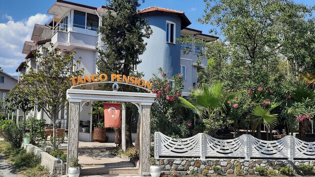 A building with a sign reading 'TANGO PENSON' and a flag. - TANGO PANSIYON (Koycegiz)