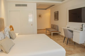 A hotel room with a bed, a desk, a chair, a whiteboard, and a framed picture on the wall. - TROPICAL de SOL CARIBE playa LOS CORALES (Bavaro)