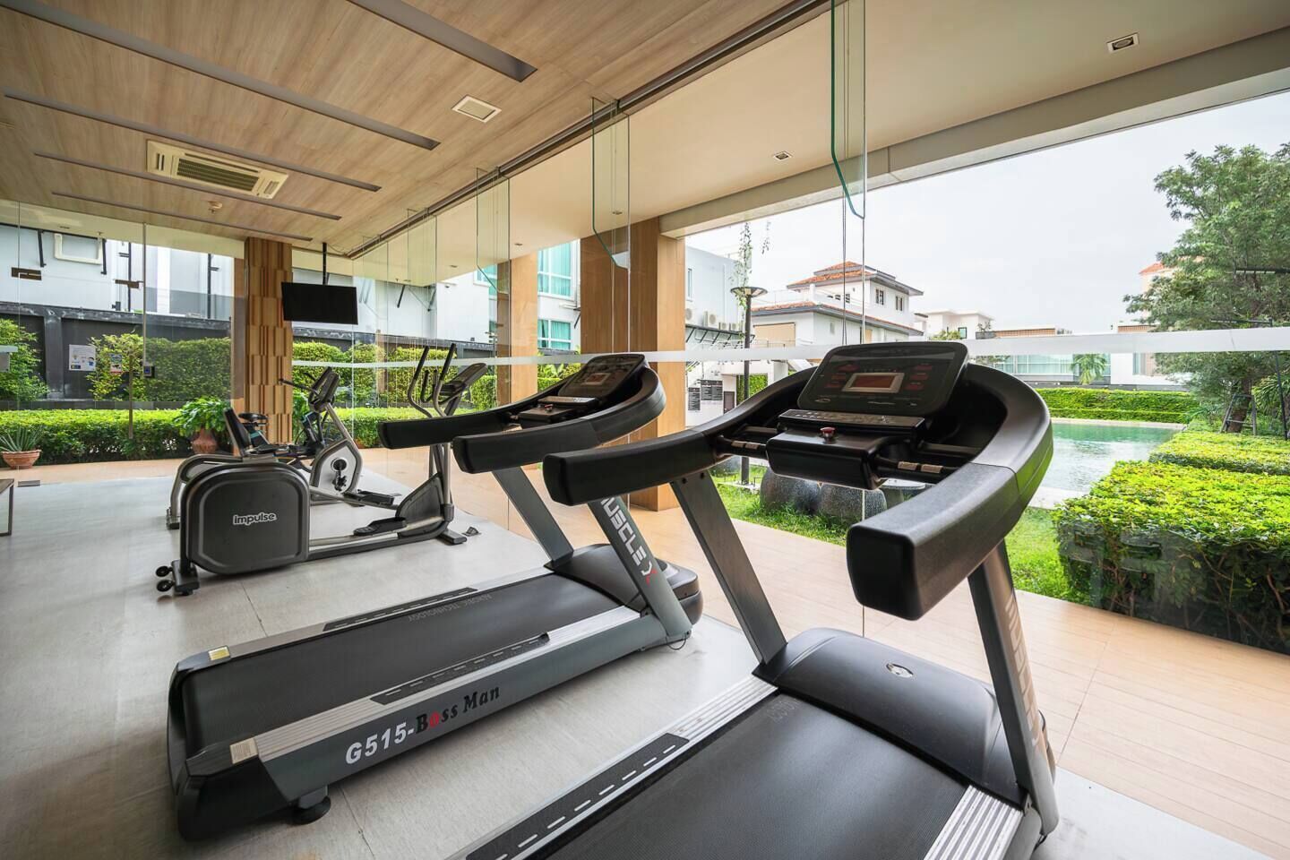 A gym with treadmills, an elliptical, and a stationary bike.