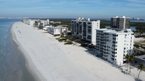 A beachfront hotel with multiple buildings, a sandy beach, and a view of the ocean. - Gulf-Front Bonita Beach, FL Condo -  Private Beach Access + Pool / Gulf views (Bonita Springs)