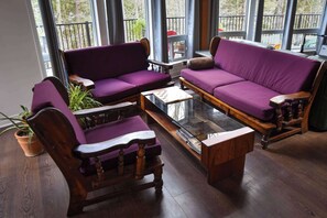 A room with two purple sofas, a wooden coffee table, and a potted plant. - Rosseau Cathedral Grove (Rosseau)