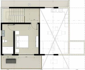 A hotel floor plan with a central corridor, multiple rooms, a seating area, and a small outdoor space.