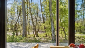 A wooden deck with a view of a forest. - 4 Star Holiday Home in Hasle (Hasle)