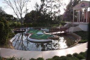 A miniature golf course with a pond, a bridge, and a pavilion. - Cozy Apartment in Vilamoura Marina with Pool & Balcony (vilamoura)