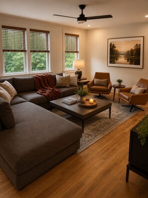 A living room with a sectional sofa, two armchairs, a coffee table, a floor lamp, and a painting on the wall. - Collins River Farmhouse (McMinnville)