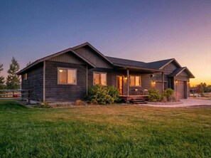 A two-story house with a front porch, a covered entryway, and a well-maintained lawn. - Targhee & Teton Getaway (Driggs)