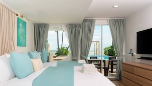 Ein Hotelzimmer mit Bett, Fernseher, Meerblick und einem Balkon mit Pool.
