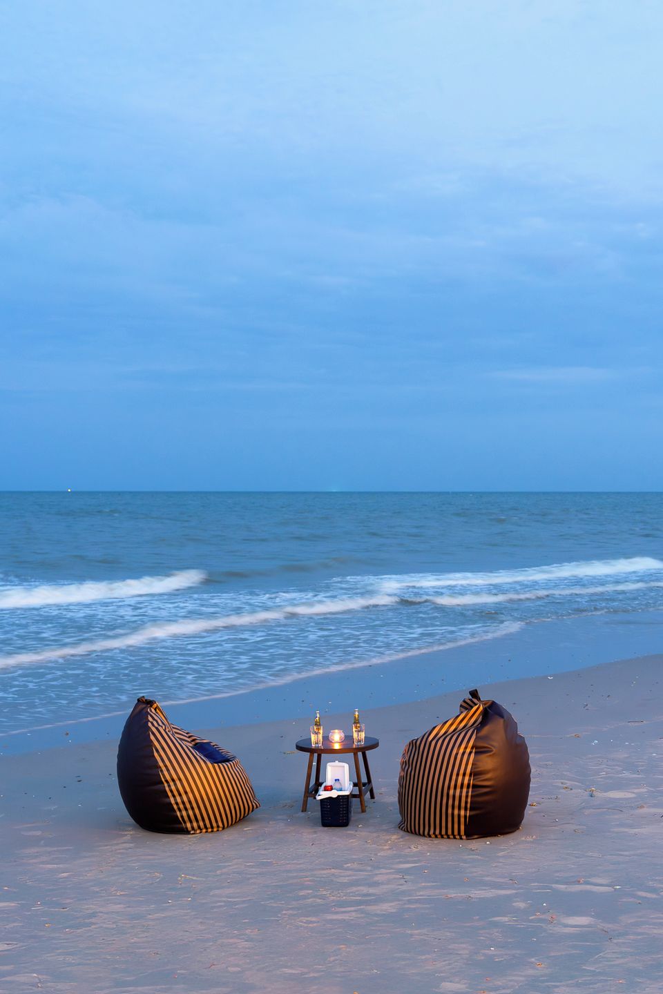 Beachfront sunset seating with ocean views and cozy evening ambiance