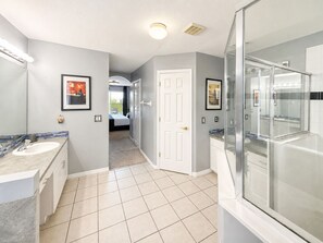 A modern bathroom with a glass shower, a sink, and a toilet. - Star Wars & Wizards Themed XL Pool Home Near Disney (Davenport)