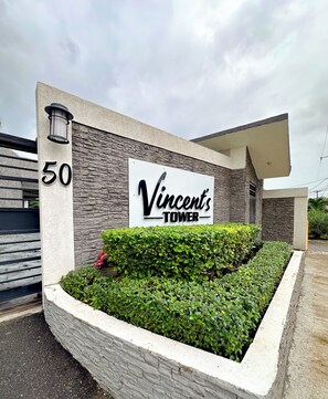 A building with a sign reading 'Vincent's Tower' and the number '50' on a column. - Cozy view of the Harbour (Kingston)