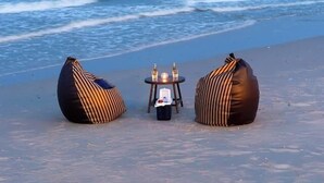 A beach with two bean bags and a small table with bottles. - Wander at Bayside 19 | Upstairs Sea-View King Room (sleeps up to 4) (Hua Hin)