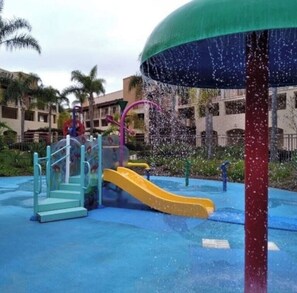 A water play area with slides and a water fountain.