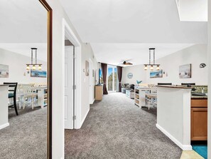 A spacious kitchen with a dining area, a large window, and a ceiling fan. - Family Resort, Garden View 3rd FL, Pools, Beach walk and shuttle (Destin)