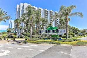 A hotel named 'The Palms of Destin' with a modern architectural design, surrounded by palm trees and well-maintained landscaping. - Family Resort, Garden View 3rd FL, Pools, Beach walk and shuttle (Destin)