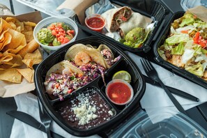 A meal with tacos, guacamole, salsa, and chips. - Suites at Waterside (Branson)