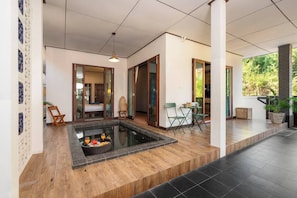 A modern hotel room with a private pool, wooden flooring, and a dining area with outdoor seating. - Walk2Beach-FullKitchen-Fence-Garden-BBQ-Wifi-AC (Hua Hin)