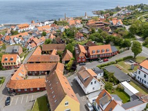 A coastal village with traditional architecture, narrow streets, and a prominent church steeple. - 4 Star Holiday Home in Allinge (Allinge)