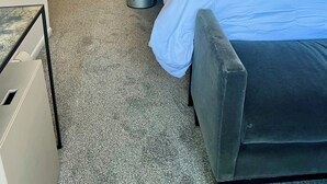 A hotel room with a bed, bedside table, and a kitchenette area. - Totally refreshed Studio. Central Core. Season thru Sept. 15 or 30 day min. (Aspen)