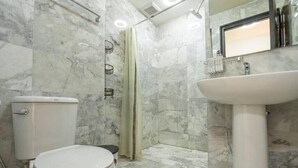A bathroom with a toilet, shower, and sink. - MBC MaiKhao 1BR Condo•Poolside•Walk 2 Beach C194 (Tambon Mai Khao)
