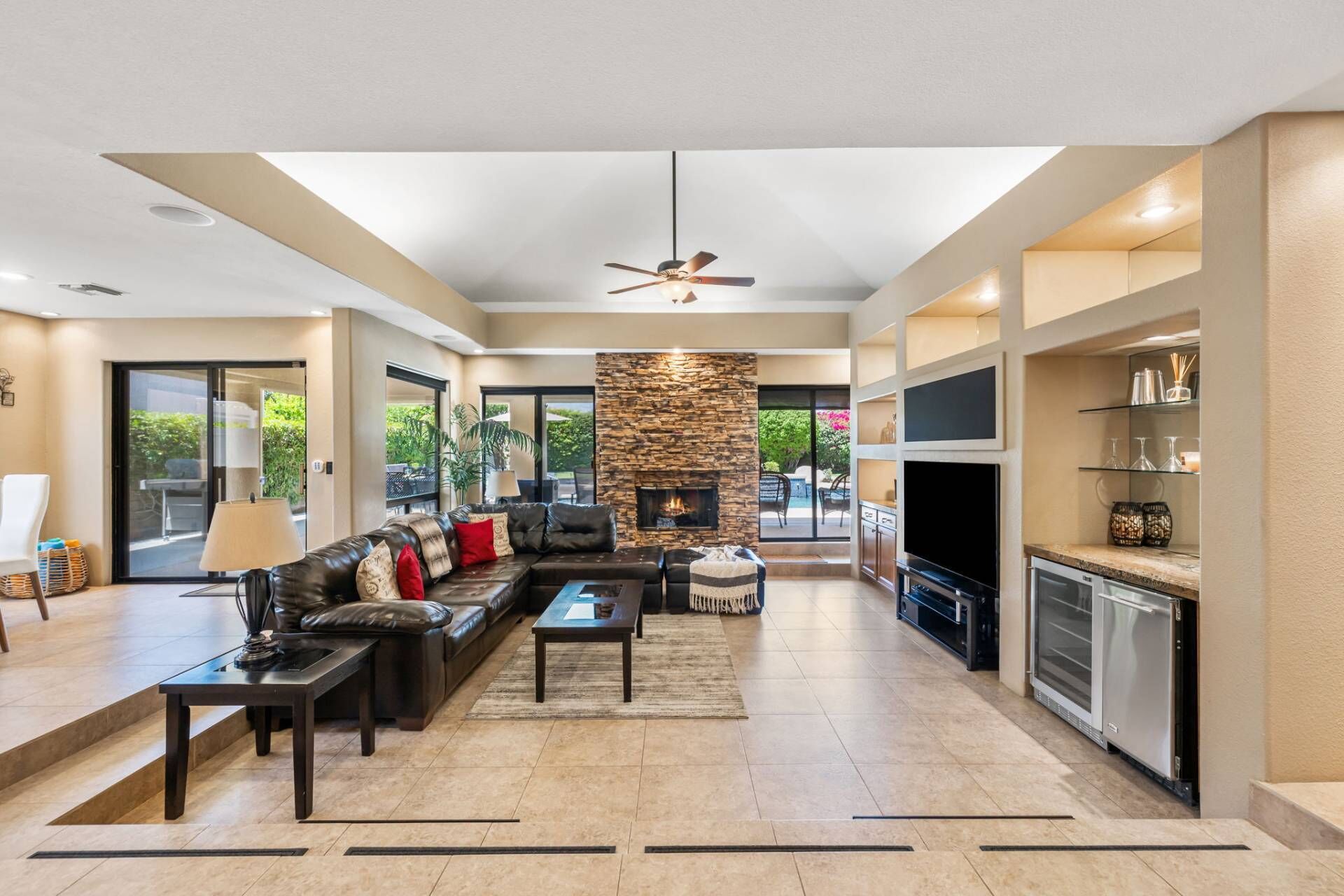A spacious living area with a fireplace, a dining area, and a kitchen with a built-in oven.