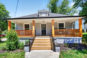 A two-story house with a porch, a front door, and a small window. - Newly Renovated Furnished Home | Ideal for Corporate & Insurance Housing (Salisbury)