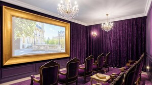 A room with purple velvet curtains, gold-framed chairs, a chandelier, and a framed window with a city view. - Icon Vallarta · Style, Comfort and Pool (Puerto Vallarta)