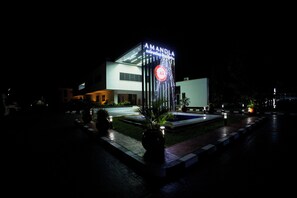 A modern building with a sign reading 'AMANDA' and a water feature in front. - Amandla Conference and Resorts (Ilishan)