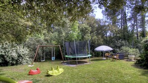 A backyard with a swing set, trampoline, and outdoor furniture. - Villa I Pini - PORTO VECCHIO (PORTO VECCHIO)