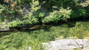 A clear river with rocky banks and dense greenery. - Travu Valley 2 (VENTISERI)