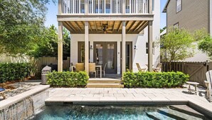 A two-story house with a covered patio, a swimming pool, and a fenced backyard. - New Apres Beach, Sleeps 14, Private Pool, 3 Min walk to the beach, Main House + Carriage (Inlet Beach)
