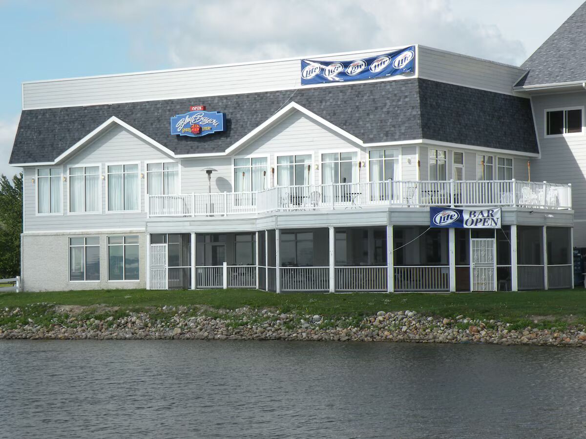 A waterfront building with a bar named 'Byrne's Bar' and 'Lite' beer signs.