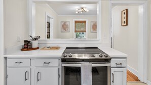 A kitchen with a stove, oven, and cabinets. - Charming Coastal Retreat with Live Oaks (Georgetown)