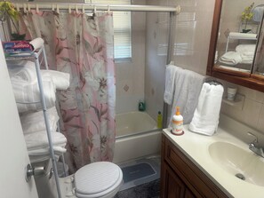 A bathroom with a shower, toilet, sink, and a towel rack. - Apartment in Elmont (Elmont)