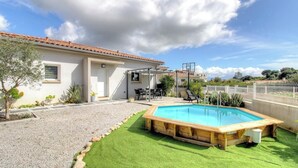 A residential property with a swimming pool, patio furniture, and a covered outdoor seating area. - Le Spurtone - ALATA - Gîte (ALATA)