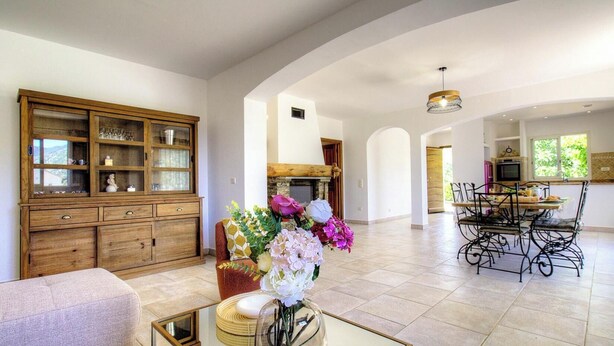 A spacious living area with a wooden cabinet, a dining table with chairs, and a fireplace. - Santa Maria - PIETRALBA (PIETRALBA)
