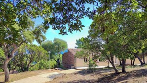 A building with a stone facade, surrounded by trees and a clear sky. - Bella vista 4 - SAINTE LUCIE DE PORTO VECCHIO (SAINTE LUCIE DE PORTO VECCHIO)