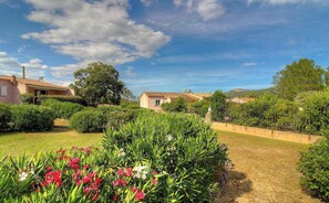 A residential area with houses, a garden with flowers, and a clear sky. - A mini villa with swimming pool less than 5 kilometers from the beach (PORTO VECCHIO)