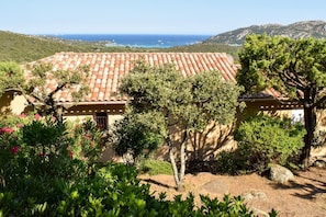 A Mediterranean-style villa with terracotta tiled roofs, surrounded by lush greenery and overlooking a coastal landscape. - Casa Ghjulia - PORTO VECCHIO (PORTO VECCHIO)