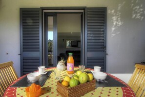 A table with a fruit basket, a bottle of orange juice, and a pitcher. - CAPRIONO - SERRA DI FERRO (SERRA DI FERRO)